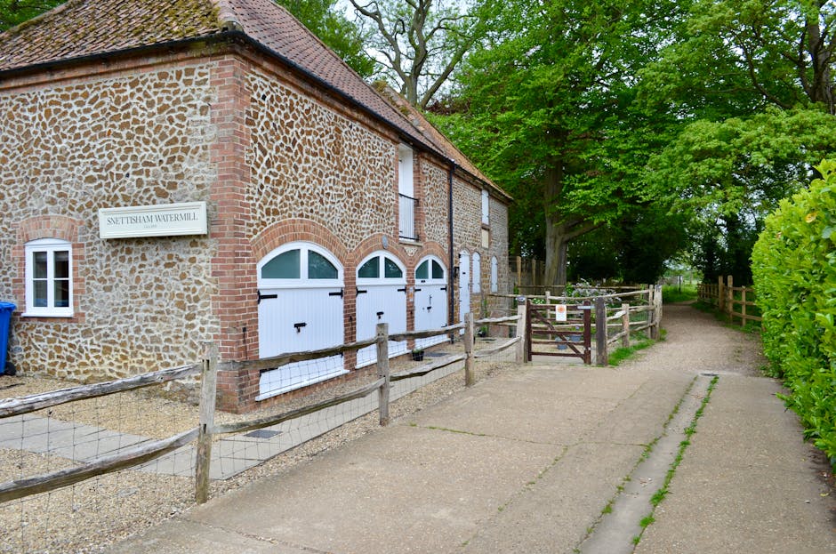 Restored country barn-conversion holiday cottage with a dog in the garden — typical Original Cottages East Anglia property