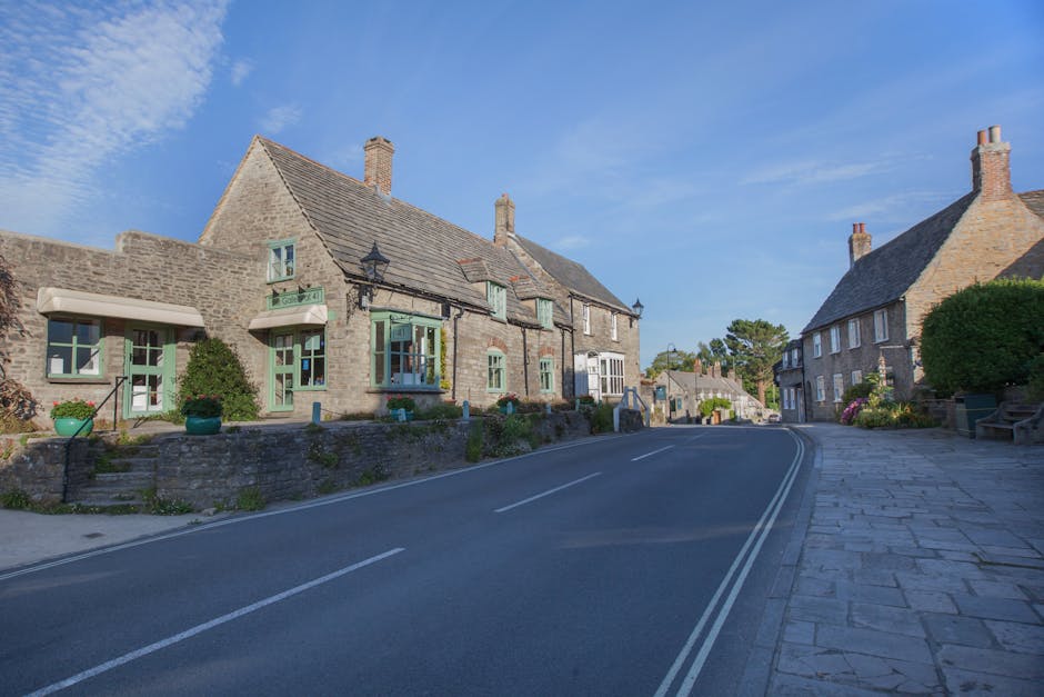 Traditional Dorset stone cottage in countryside with gardens, typical of pet-friendly self-catering in the Jurassic Coast region.